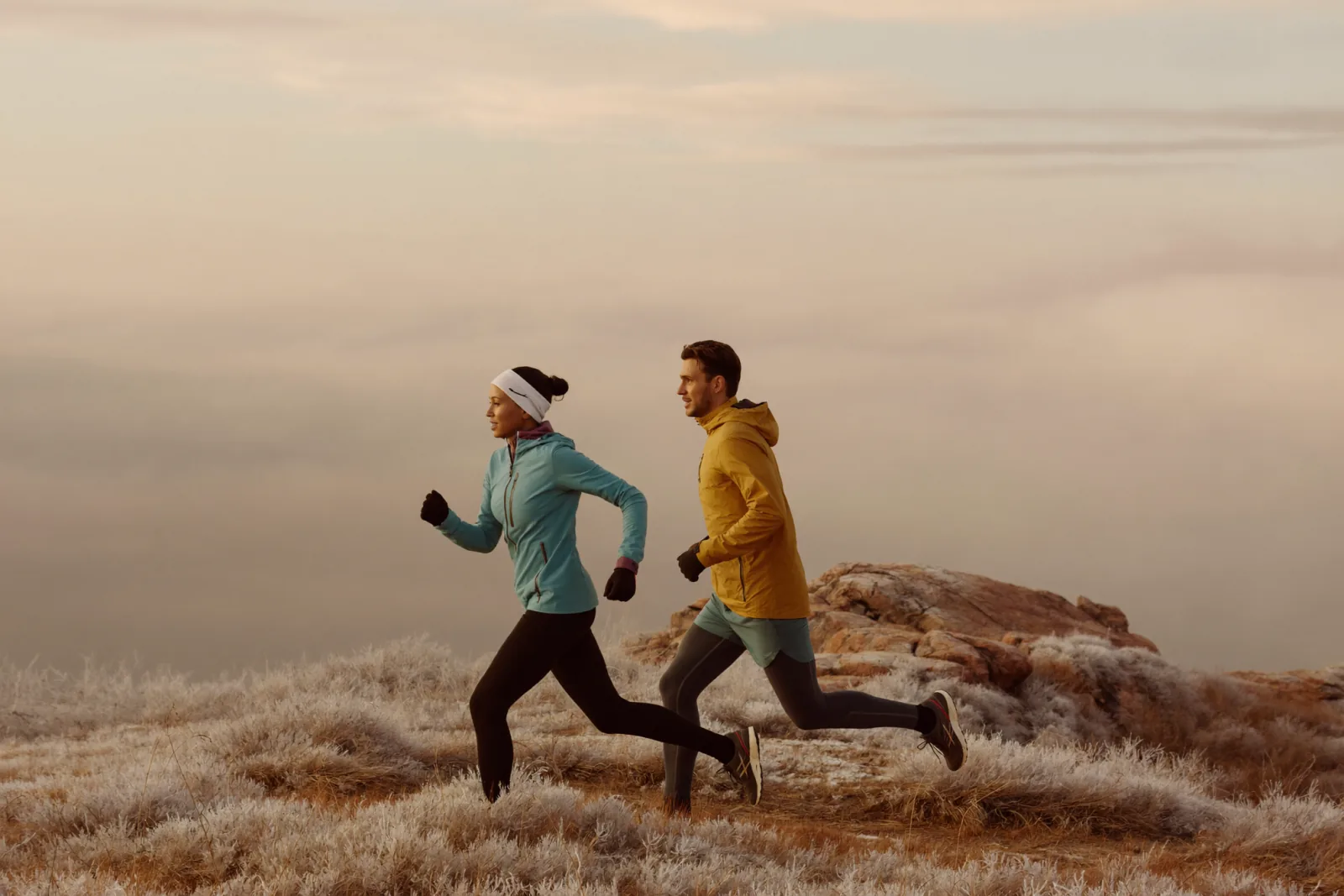Two people trail running at sunrise